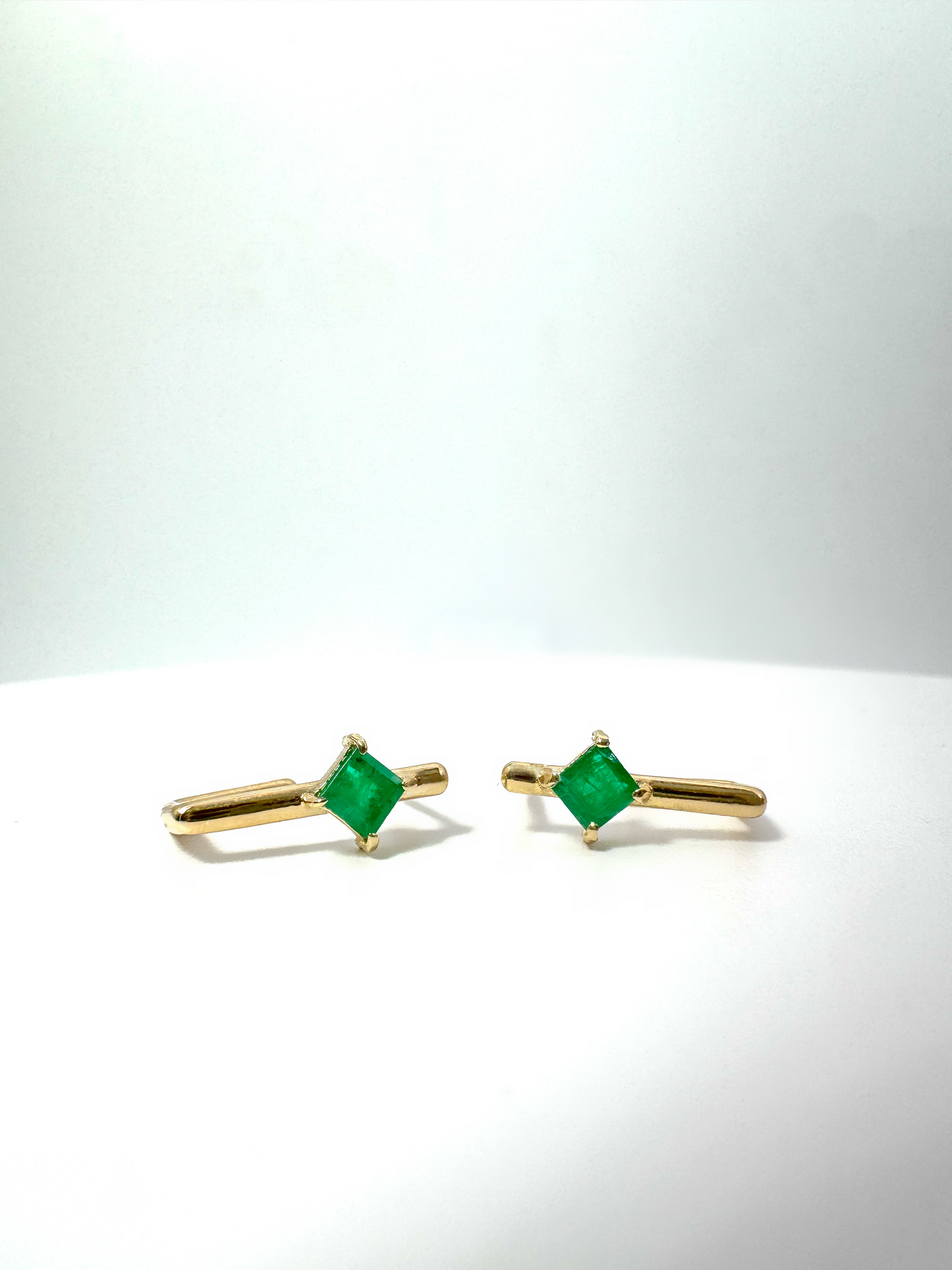 Geometric 14k gold earrings with natural Colombian emeralds, featuring a square-cut stone and minimalist style, perfect for everyday elegance.